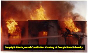Jeff Lavvorn battles a spectacular two-alarm railroad warehouse blaze, Atlanta, Georgia, November 26, 1991.