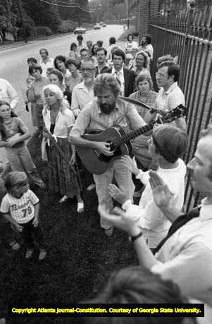 Guy and Candie Carawan, and other anti-death penalty protesters, gathering in song at Georgia Governor George Busbee's mansion, at an anti-death penalty demonstration against Jack Potts' scheduled execution, Atlanta, Georgia, June 3, 1980.