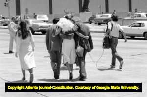 Diane Nicholson, former girlfriend of convicted murder Jack Potte, helped from the federal building by her husband, and Team Defense law student Chris Stone, Atlanta, Georgia, June 10, 1980.