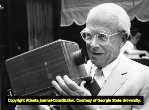 Former Atlanta Mayor Ivan Allen, Jr., examining a turn-of-the-century telephone model, Atlanta, Georgia, August 26, 1977.