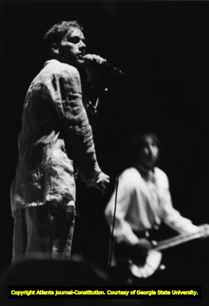 Michael Stipe of R.E.M. sings, while Pete Buck plays guitar, Omni, Atlanta, Georgia, April 1, 1989.