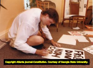 William Robbins, preparing signs at Atlanta Gay Center's Young Adult Support Group, for Gay Pride parade, Atlanta, Georgia, June 18, 1991.