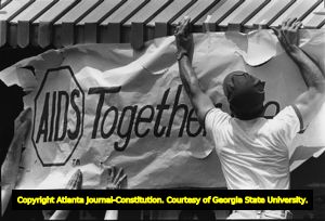 AIDS banner goes up at the gay pride rally site, Atlanta, Georgia, June 25, 1983.