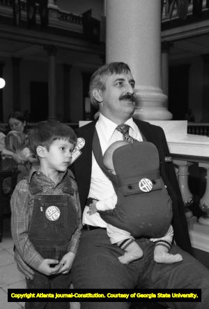 Father and his two children, supporting Equal Rights Amendment ratification, standing by as the Georgia Senate votes, Atlanta, Georgia, January 21, 1980.