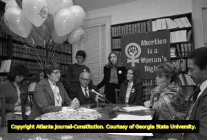 Lawyer Margie Pitts Hames, Dr. Newton Long, Denise McLaughlin, Kay Scott, and a reporter, on anniversary of Doe v Bolton, Atlanta, Georgia, January 22, 1982. Lynne Randall is standing behind Dr. Long.