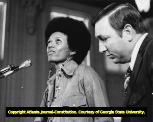 Marion "Deboe" Lee, with Assistant Police Chief J.L. Mullins, at hearing over Police Department's infiltration of the Atlanta Voice publication, Atlanta, Georgia, May 29, 1974.