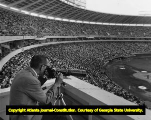 Photographer Marion Johnson photographing a baseball game, Atlanta, Georgia, 1940s?
