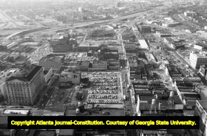 Aerial view of downtown, looking south towards I-20, showing large areas covered in parking lots, Atlanta, Georgia, January 16, 1980.
