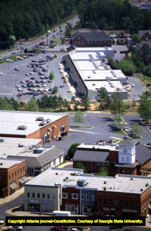 Aerial view of Merchants Walk Shopping Center (foreground) and Market Plaza Shopping Center, looking southeast, Cobb County, Georgia, April 21, 1988.
