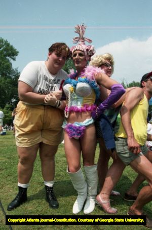 Costumed couple posing with others at the 25th annual Gay Pride Parade, Piedmont Park, Atlanta, Georgia, June 25, 1995.