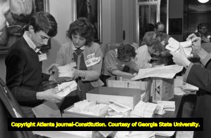 Opponents of the ERA handling notices during the Georgia State House of Representatives' vote on the ratification for the ERA, Atlanta, Georgia, January 20, 1982.
