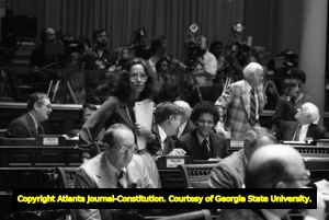 Georgia State Representative Cathey Steinberg (standing) and Senator Thomas F. Allgood (seated in foreground), during the Georgia Senate's debate on ratification of the Equal Rights Amendment, Atlanta, Georgia, January 21, 1980.