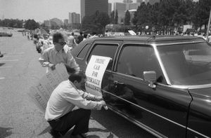 Putting signs on "Pride car for physically challenged," in the 17th annual Gay Pride Parade, Atlanta, Georgia, June 21, 1986.