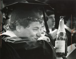 College graduate, in gown, with bottle of spumante, Atlanta, Georgia, 1980s?