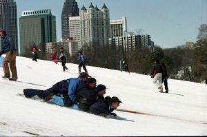 Sledders enjoying the snow in Piedmont Park during the 1993 blizzard, Atlanta, Georgia, March 1993.