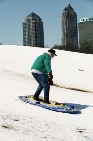 Sledder enjoying the snow in Piedmont Park during the 1993 blizzard, Atlanta, Georgia, March 1993.