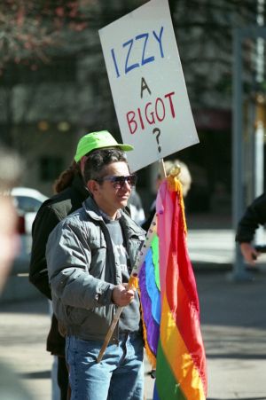 Demonstrator, Jon Ivan Weaver, with a gay pride flag at the Olympics-Out-of-Cobb protest, Woodruff Park, Atlanta, Georgia, February 27, 1994.