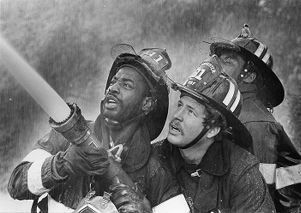 Three firefighters in dramatic photograph, Atlanta, Georgia, November 13, 1984.