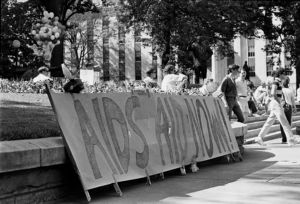 "AIDS Aid Now," sign at the Georgia State Capitol AIDS rally and vigil, Atlanta, Georgia, May 7, 1988.
