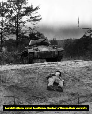 Rescue exercise at Fort Benning, Georgia, rescue tank approaching "wounded" soldier, 1953.