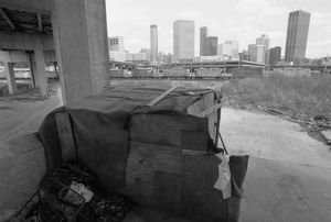 Homeless living area behind the Omni Coliseum, with view of downtown in distance, Atlanta, Georgia, August 3, 1988.
