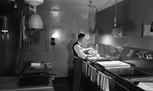 Inspecting a print in the Atlanta Journal darkroom, Atlanta, Georgia, 1949.