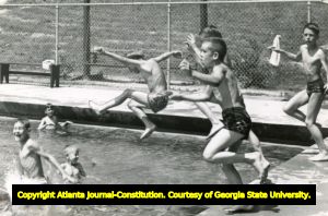 School kids jumping into swimming pool, Atlanta, Georgia, 1953.