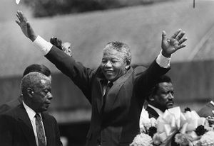 Anti-apartheid leader, Nelson Mandela, waving to the crowd after laying a wreath at the crypt of Dr. Martin Luther King Jr., Atlanta, Georgia, June 27, 1990.