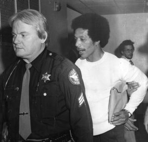 Convicted murderer and death row inmate, Warren McCleskey, being escorted back to his cell, Jackson, Georgia, 1983.
