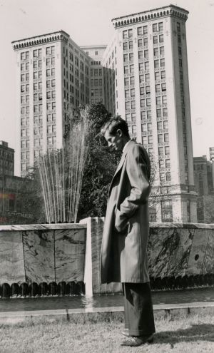 Poet Byron Herbert Reece standing at the Hurt Park fountain, Atlanta, Georgia, 1950s.