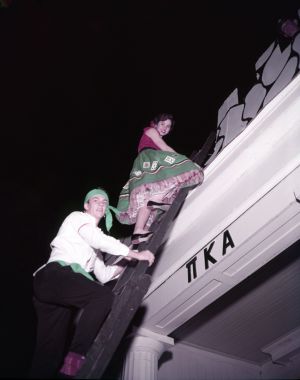Climbing to the roof during a Pi Kappa Alpha costume party, Athens, Georgia, January 22, 1957.