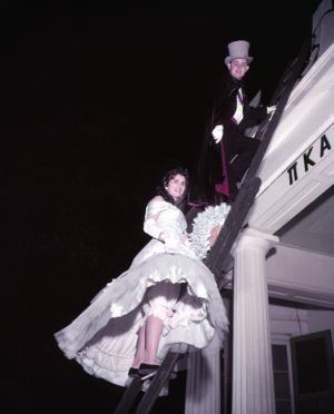 Climbing to the roof during a Pi Kappa Alpha costume party, Athens, Georgia, January 22, 1957.