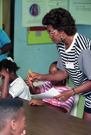 HIV/AIDS awareness and information instructor Sara Nash working with children, Harrison Square public housing, Gainesville, Georgia, July 28, 1992.