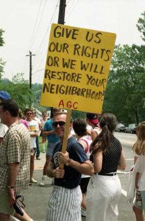 Gay Pride Day parade: sign reads, "Give Us Our Rights or We Will Restore Your Neighborhood!" Atlanta, Georgia, June 23, 1991.