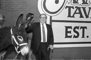 Democrat Manuel Maloof with donkey, outside Manuel's Tavern, part of Maloof's re-election campaign for CEO of DeKalb County, Atlanta, Georgia, October 7, 1987.