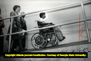 Gwen Dixon leads a group up a ramp that is accessible to wheelchairs.