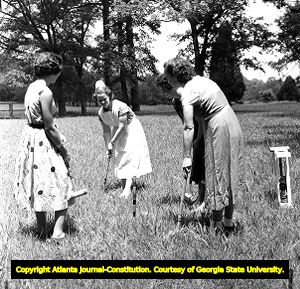 Student nurse, Patricia Welborn, playing croquet with patients at Milledgeville State Hospital, Milledgeville, Georgia, 1950.