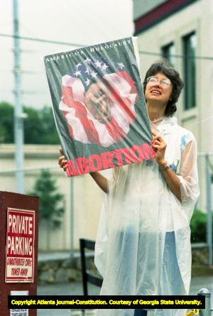 Woman picketing with a pro-life sign in response to the Supreme Court ruling in Webster v. Reproductive Health Services, Atlanta, Georgia, July 3, 1989.