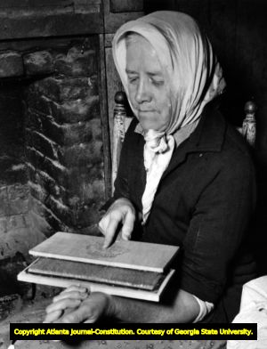 Mrs. Connice Holden, Aunt Fanny's daughter, is carding wool, Georgia, ca. 1930s; 1940s.