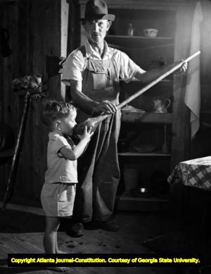 Lant J. Ellers, Ed Watkins' grandson, drinks from a long-handled gourd, Mountain City, Georgia, ca. 1930s; 1940s.