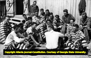 "Hell Hole Becomes a Haven," photograph for the Atlanta Journal with reporter Pete Craig (center, with back to camera), 1941?