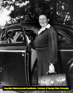 Visiting nurse, holding a briefcase, visits a rural area of Georgia, January 7, 1945.
