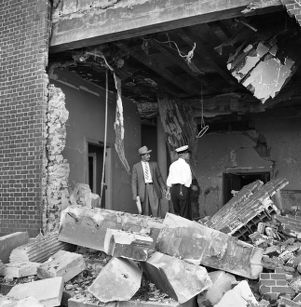 Detective W. K. Perry and a fireman surveying the Hebrew Benevolent Congregation (later known as simply The Temple) following a racially motivated bombing, Atlanta, Georgia, October 12, 1958.