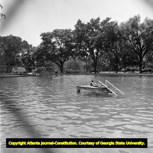 African Americans and whites still congregate separately in the newly integrated Lake Meer, Piedmont Park, Atlanta, Georgia, June 12, 1963.