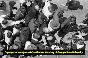 Lester Maddox's being interviewed surrounded by his followers at the Atlanta Journal Constitution Building, Atlanta, Georgia, June 4, 1970.