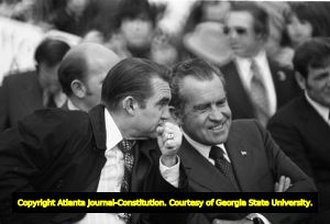 Alabama Governor George Wallace and President Richard Nixon conversing on stage at a Honor America Day event, Huntsville, Alabama, February 18, 1974.