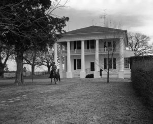 Colonel William O. Poindexter and his wife in front of their mansion, Rebel House (formerly the Rutlidge Home plantation), LaGrange, Georgia, January 27, 1959.