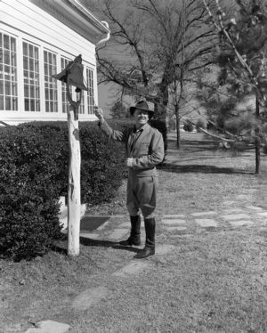 Colonel William O. Poindexter ringing a dinner bell, Rebel House (formerly the Rutlidge Home plantation), LaGrange, Georgia, January 27, 1959.