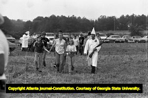 People, including a mother and a her two children, arriving at a Ku Klux Klan rally in Buchanan, Georgia, June 20, 1981.