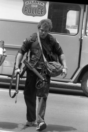 SWAT team member entering Atlanta's F.B.I. headquarters during a hostage situation, Atlanta, Georgia, June 29, 1981.